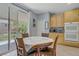 Cozy dining area adjacent to the kitchen, with a view of the landscaped backyard at 10385 Grassyrock Ct, Las Vegas, NV 89129