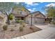 Charming two-story home with well-maintained landscaping, a three-car garage, and inviting curb appeal at 10385 Grassyrock Ct, Las Vegas, NV 89129