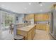 Open-concept kitchen with wooden cabinets and stainless steel appliances and sliding glass door at 10385 Grassyrock Ct, Las Vegas, NV 89129