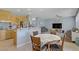 Open kitchen with a breakfast bar and dining area, offering a view into the comfortable living room at 10385 Grassyrock Ct, Las Vegas, NV 89129