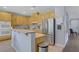 Updated kitchen featuring stainless steel appliances, light wood cabinets and breakfast bar at 10385 Grassyrock Ct, Las Vegas, NV 89129