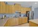 Well-equipped kitchen featuring oak cabinets, modern appliances, and ample counter space at 10385 Grassyrock Ct, Las Vegas, NV 89129