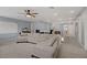 Bright living room features a comfortable beige sectional and modern ceiling fan at 10385 Grassyrock Ct, Las Vegas, NV 89129