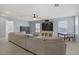 Spacious carpeted living room featuring a ceiling fan, lots of windows and neutral color palette at 10385 Grassyrock Ct, Las Vegas, NV 89129