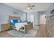 Comfortable main bedroom with ceiling fan, natural light, wood-look furniture and blue accents at 10385 Grassyrock Ct, Las Vegas, NV 89129