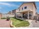 Spacious backyard with covered patio, artificial grass, and low-maintenance landscaping at 1141 Cactus Rock St, Henderson, NV 89011