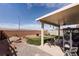 Backyard area features a covered patio, rock garden and built in fire pit at 1141 Cactus Rock St, Henderson, NV 89011