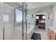 Modern bathroom featuring a tub, a glass-enclosed shower, and an arched doorway at 1141 Cactus Rock St, Henderson, NV 89011