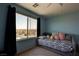 Bright bedroom with a large window overlooking the neighborhood street view at 1141 Cactus Rock St, Henderson, NV 89011