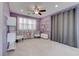 Well-lit bedroom with neutral carpet, and large window at 1141 Cactus Rock St, Henderson, NV 89011