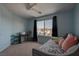 Comfortable bedroom with a twin bed, a desk area, and a large window at 1141 Cactus Rock St, Henderson, NV 89011