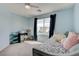 Cozy bedroom with a desk, large window, and comfortable lounging area at 1141 Cactus Rock St, Henderson, NV 89011