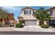 Two-story home featuring a two-car garage and desert landscaping at 1141 Cactus Rock St, Henderson, NV 89011