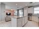 Open kitchen with granite countertops, white cabinetry, and views of the living area at 1141 Cactus Rock St, Henderson, NV 89011
