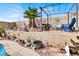 Picturesque backyard featuring a sitting area, lush landscaping, and a serene retreat at 1229 Swanbrooke Dr, Las Vegas, NV 89144
