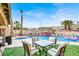 Beautiful backyard features a pool with a waterfall, spa, and lush landscaping at 1229 Swanbrooke Dr, Las Vegas, NV 89144
