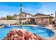Stunning backyard oasis featuring a sparkling pool, spa, and covered patio area at 1229 Swanbrooke Dr, Las Vegas, NV 89144