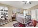 Cozy bedroom with an ornate bed frame, eclectic decor, and ample natural light from the windows at 1229 Swanbrooke Dr, Las Vegas, NV 89144