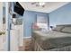 Comfortable bedroom with blue walls, a queen-sized bed, and natural light from the window at 1229 Swanbrooke Dr, Las Vegas, NV 89144