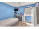 Bright bedroom features blue walls, ample natural light, and a stylish vanity area at 1229 Swanbrooke Dr, Las Vegas, NV 89144