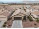 Inviting single Gathering home showcasing a two-car garage and desert landscaping at 1229 Swanbrooke Dr, Las Vegas, NV 89144