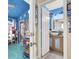 Hallway featuring a blue accent wall, doorway to a bathroom, and doorway to another room at 1229 Swanbrooke Dr, Las Vegas, NV 89144