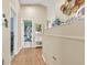 Hallway with wood-look flooring leading to another room, with decor on top of a built-in cabinet at 1229 Swanbrooke Dr, Las Vegas, NV 89144