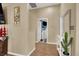 Hallway with neutral colors, wood floors, decorative mirror and a view to an open room at 1229 Swanbrooke Dr, Las Vegas, NV 89144