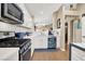 Well-lit kitchen featuring stainless steel appliances, white cabinetry, and a functional layout at 1229 Swanbrooke Dr, Las Vegas, NV 89144