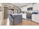 Modern kitchen featuring stainless steel appliances, a center island with seating, and hardwood flooring at 1229 Swanbrooke Dr, Las Vegas, NV 89144