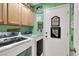 Functional laundry room with modern appliances, ample cabinet space, and decorative touches at 1229 Swanbrooke Dr, Las Vegas, NV 89144