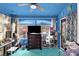 Living room featuring blue walls, blue carpet, a ceiling fan, and ample natural light at 1229 Swanbrooke Dr, Las Vegas, NV 89144