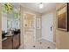 Hallway into bathroom with mirrored wall, granite vanity, and garden tub at 125 E Harmon Ave # 2318, Las Vegas, NV 89109