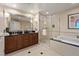 Bathroom featuring double vanity, standalone shower, and large soaking tub at 125 E Harmon Ave # 2318, Las Vegas, NV 89109