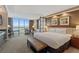 Bright bedroom featuring city views, seating area, modern furnishings, and comfortable king bed at 125 E Harmon Ave # 2318, Las Vegas, NV 89109