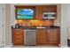 Cherry cabinet kitchenette with microwave, stainless refrigerator, and granite countertop at 125 E Harmon Ave # 2318, Las Vegas, NV 89109