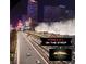 Action on the Formula 1 track on the Vegas strip, surrounded by prominent hotels and excited crowds at 125 E Harmon Ave # 2318, Las Vegas, NV 89109