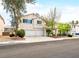 Charming two-story home boasts a well-manicured lawn, mature trees, and a spacious three-car garage at 1307 Bayleaf Terrace Ave, Henderson, NV 89014