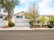 Charming two-story home boasts a well-manicured lawn, mature trees, and a spacious three-car garage at 1307 Bayleaf Terrace Ave, Henderson, NV 89014