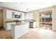 Bright kitchen features white cabinets, granite countertops, and an island with sliding door access to the backyard at 1307 Bayleaf Terrace Ave, Henderson, NV 89014