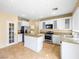 Bright kitchen with white cabinetry, stainless steel appliances, granite countertops, and a kitchen island at 1307 Bayleaf Terrace Ave, Henderson, NV 89014