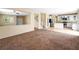 Open living space with stairs, an adjoining kitchen, and carpeted floors at 1307 Bayleaf Terrace Ave, Henderson, NV 89014