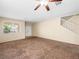 Spacious living room featuring neutral walls, plush carpeting, large windows, and a staircase at 1307 Bayleaf Terrace Ave, Henderson, NV 89014