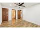 Bedroom with wood-look floors and multiple doors to an ensuite and closets at 1404 Santa Margarita St # D, Las Vegas, NV 89146