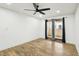 Bright bedroom with wood-look floors, ceiling fan, and sliding doors to a patio at 1404 Santa Margarita St # D, Las Vegas, NV 89146
