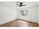 Bright bedroom with a ceiling fan and hardwood floors with a view to the outside at 1404 Santa Margarita St # D, Las Vegas, NV 89146