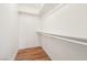 Walk-in closet with painted shelving and wood-look floor at 1404 Santa Margarita St # D, Las Vegas, NV 89146