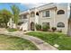 Attractive two-story condo featuring well-maintained lawn, walkway, and classic desert landscaping at 1404 Santa Margarita St # D, Las Vegas, NV 89146