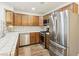 Kitchen featuring stainless steel appliances, tile backsplash, and light wood cabinets at 1404 Santa Margarita St # D, Las Vegas, NV 89146
