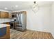 Stainless steel refrigerator in the kitchen with wood cabinets and modern light fixture at 1404 Santa Margarita St # D, Las Vegas, NV 89146